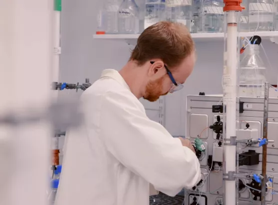 Liam working in the lab on some equipment, turned away from the camera
