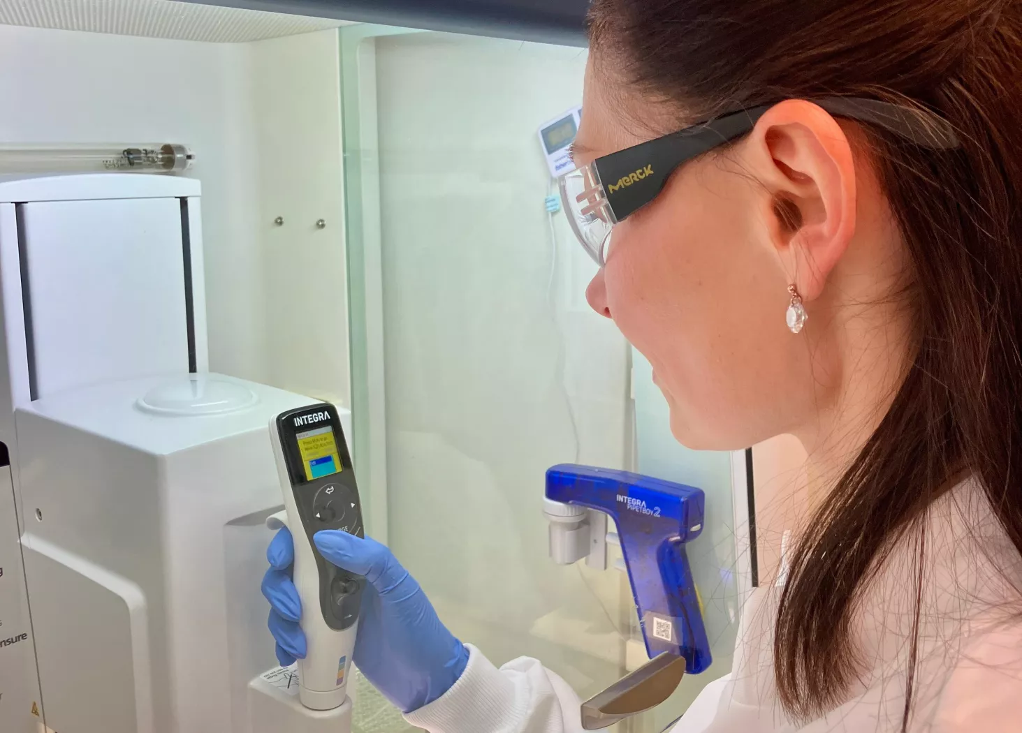 From behind, Mariia working in a cabinet in the lab